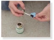 Hands applying glue to a patch over a pool container