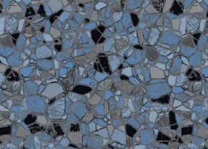 Broken glass and black obsidian shards scattered on gray concrete surface with blue sky reflections