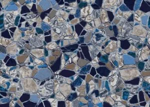Close-up of scattered pearlstone mosaic tiles in shades of blue, cream, tan, and black with grout lines between pieces