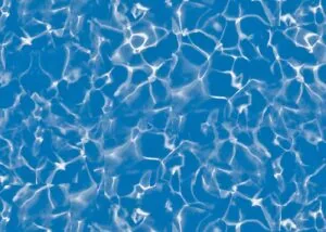Clear blue water with white light reflections and ripple patterns on surface