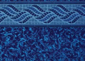 Swimming pool tile border with wavy mosaic pattern above rippling water surface
